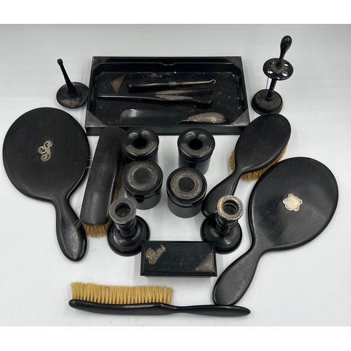 487 - A quantity of ebony and silver mounted dressing table items to include tray, candlesticks, hand mirr... 