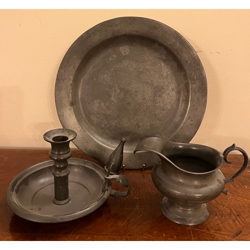 907 - Pewter to include plate 27.5cm d, chamber stick and snuffer and a jug.