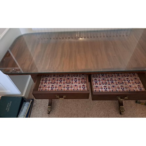 105 - A mahogany sofa table with two drawers to the front and drop leaves to each end. 66cm h x 127cm w  (... 