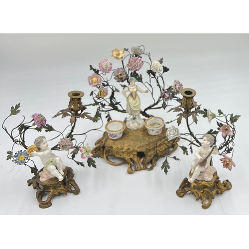 217 - Three 19thC continental, possibly Meissen porcelain and ormolu mounted figures, two with candleholde... 