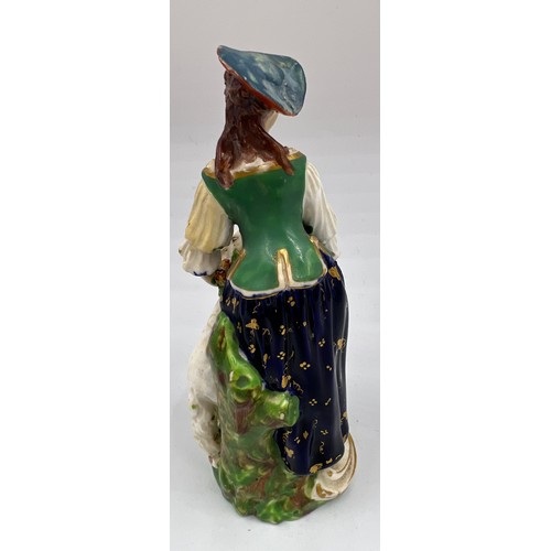 218 - An 18thC figure of a shepherdess, 13.5cm h. Marked N 40 to base.