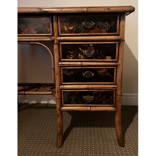 99 - A 19thC bamboo and lacquer kneehole desk with brass drop handles. 90cm w x 51cm d x 76cm h.