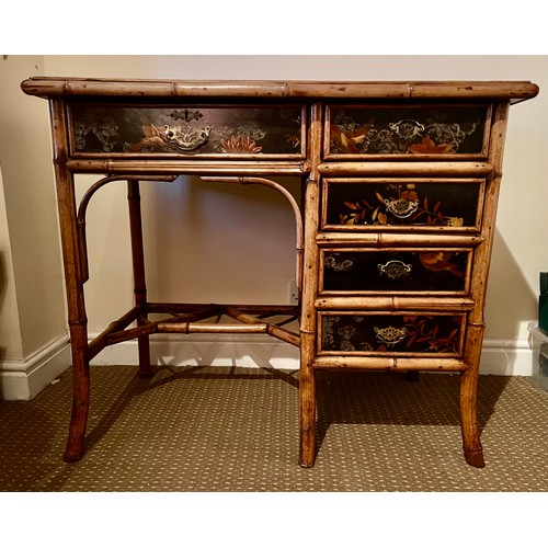 99 - A 19thC bamboo and lacquer kneehole desk with brass drop handles. 90cm w x 51cm d x 76cm h.