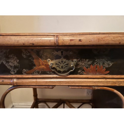 99 - A 19thC bamboo and lacquer kneehole desk with brass drop handles. 90cm w x 51cm d x 76cm h.