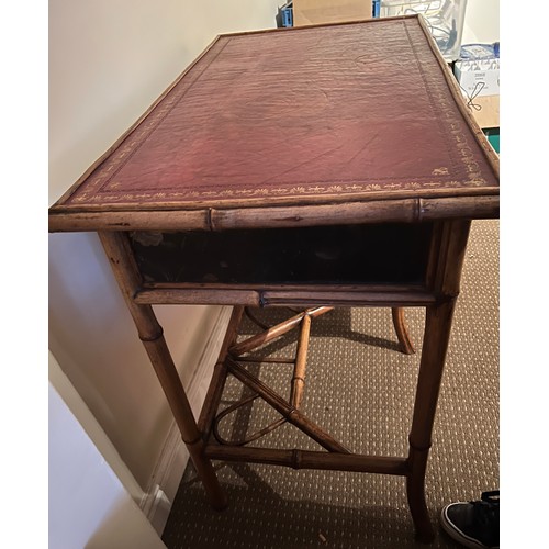 99 - A 19thC bamboo and lacquer kneehole desk with brass drop handles. 90cm w x 51cm d x 76cm h.