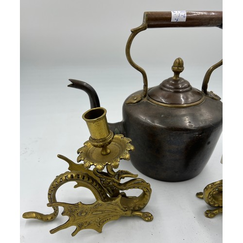 908 - A 19thC heavy copper kettle with acorn knop together with a pair of brass Griffin candlesticks 17cm ... 