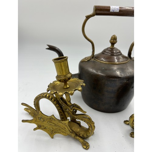 908 - A 19thC heavy copper kettle with acorn knop together with a pair of brass Griffin candlesticks 17cm ... 