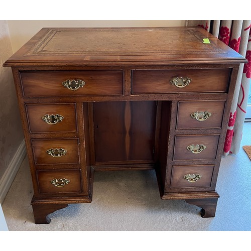 95 - A small 20thC yew wood kneehole desk with central cupboard and drawers to either side. 80cm w x 49cm... 