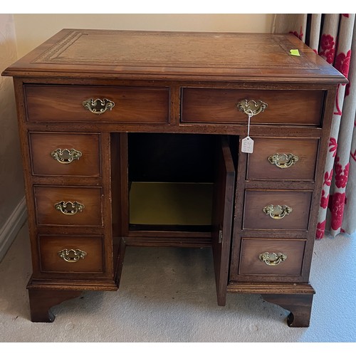 95 - A small 20thC yew wood kneehole desk with central cupboard and drawers to either side. 80cm w x 49cm... 