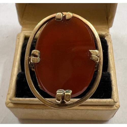 481 - A 9 carat gold ring set with oval dark orange stone. Size N. Weight 4.1gm.