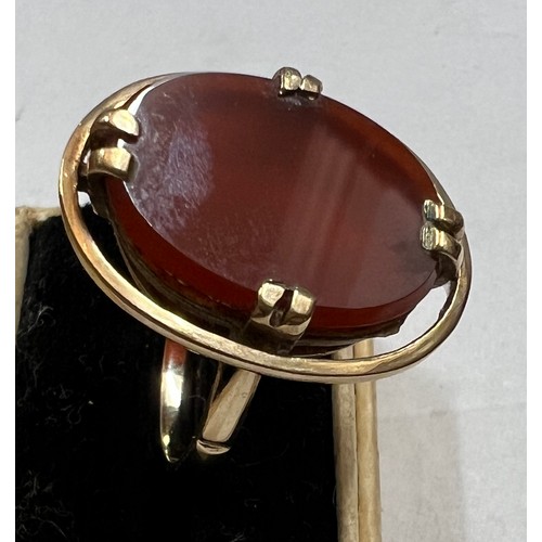 481 - A 9 carat gold ring set with oval dark orange stone. Size N. Weight 4.1gm.