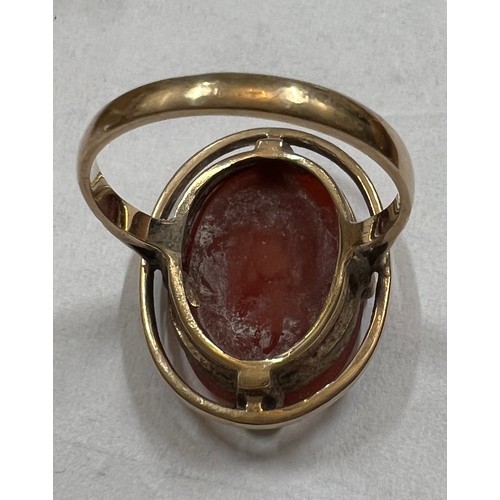 481 - A 9 carat gold ring set with oval dark orange stone. Size N. Weight 4.1gm.