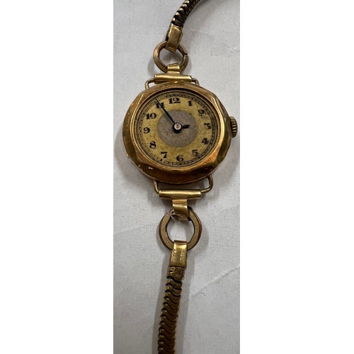 525A - An 18 carat gold cased ladies wristwatch on a rolled gold chain bracelet. Total weight 14.1gm.