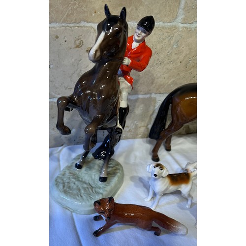 243 - Beswick to include huntsman on rearing horse, mounted huntsman, four hounds and a fox.