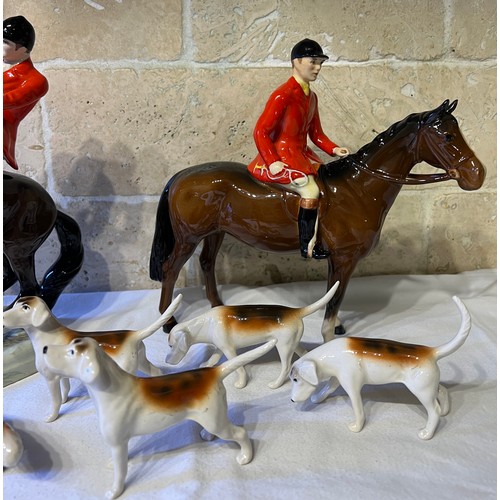 243 - Beswick to include huntsman on rearing horse, mounted huntsman, four hounds and a fox.