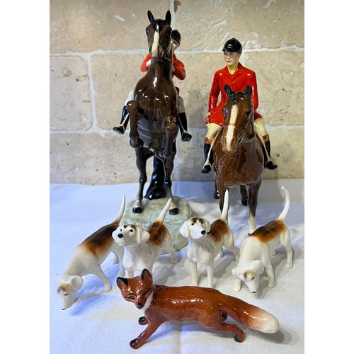 243 - Beswick to include huntsman on rearing horse, mounted huntsman, four hounds and a fox.