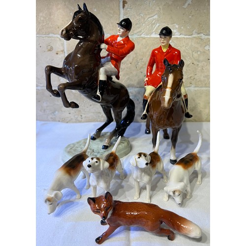 243 - Beswick to include huntsman on rearing horse, mounted huntsman, four hounds and a fox.