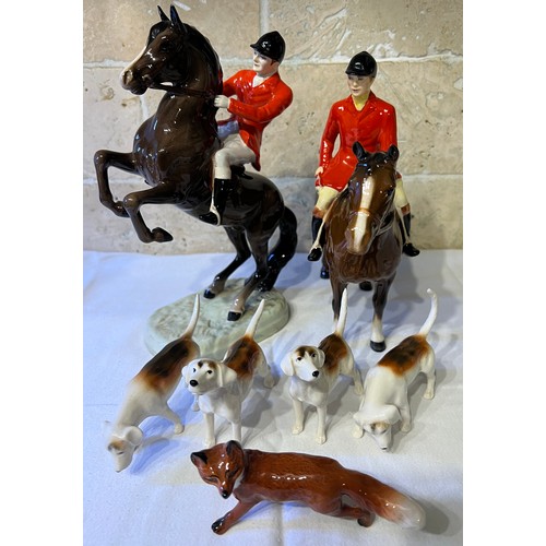 243 - Beswick to include huntsman on rearing horse, mounted huntsman, four hounds and a fox.