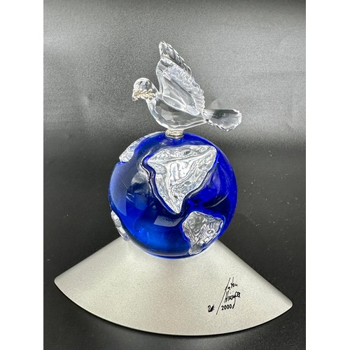 283 - Three pieces of Swarovski crystal to include The Year 2000 Globe, signed The Designer Anton Hirzinge... 