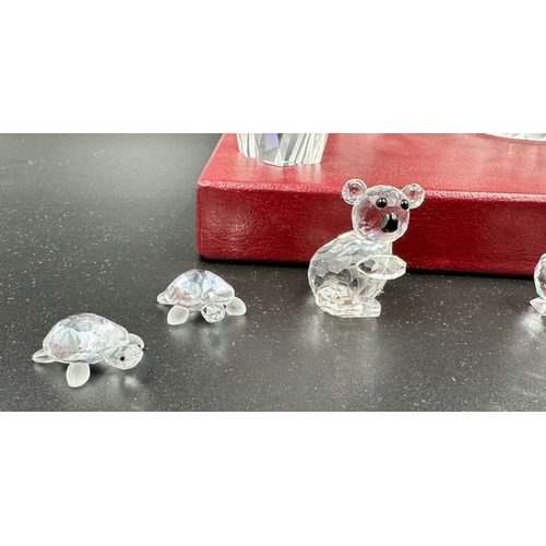 284 - A collection of 12 Swarovski Silver Crystal boxed ornaments to include penguin, owl, turtles, cat, d... 