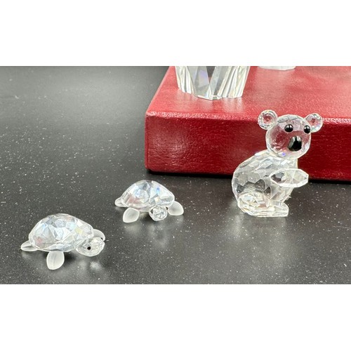 284 - A collection of 12 Swarovski Silver Crystal boxed ornaments to include penguin, owl, turtles, cat, d... 