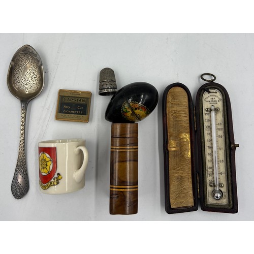 1028 - A miscellaneous lot to include a miniature leather cased thermometer, hallmarked silver preserve spo... 