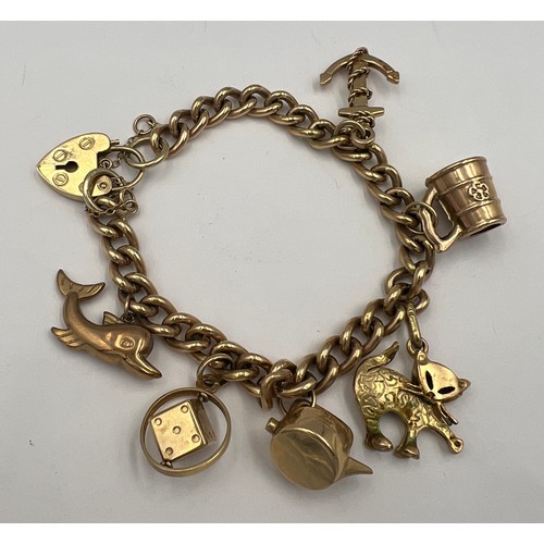 489 - A 9 carat gold charm bracelet and six charms, total weight 41gm.