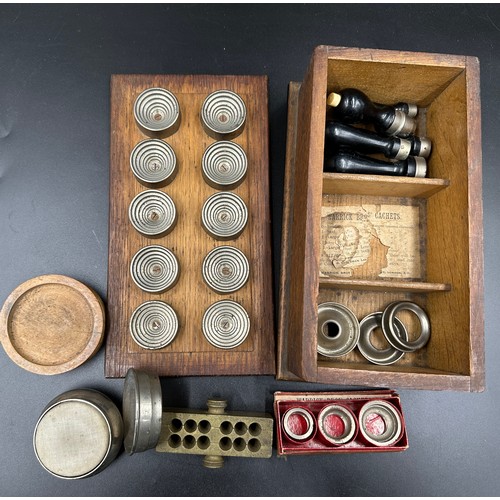 1027 - A group of pharmaceutical items to include a mahogany and brass pill machine 31cm l, by J. W. Pindar... 