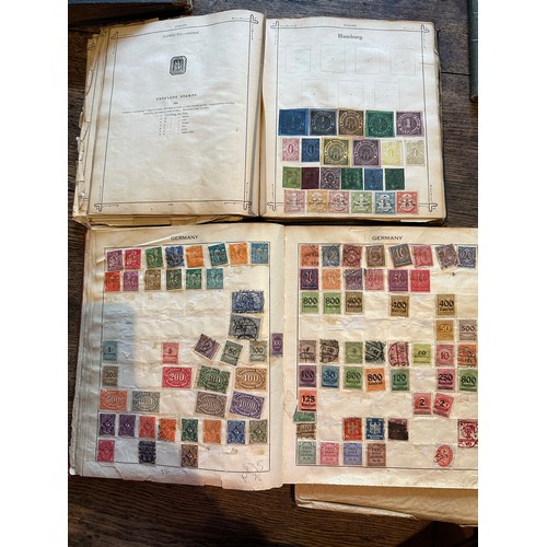 587 - Four world printed albums with mainly world stamps, some GB.