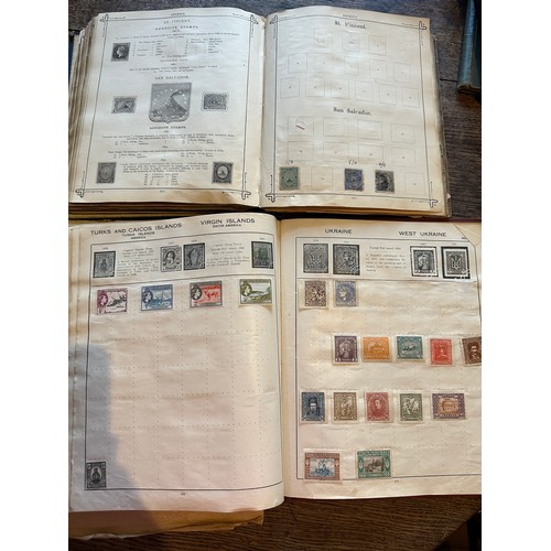 587 - Four world printed albums with mainly world stamps, some GB.