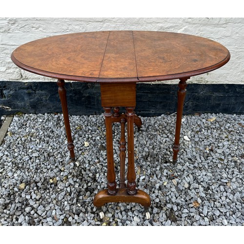 107 - A walnut sutherland table on ceramic casters. Extended 96.5 x 68 x 70cm. Folded 86 x 16cm.