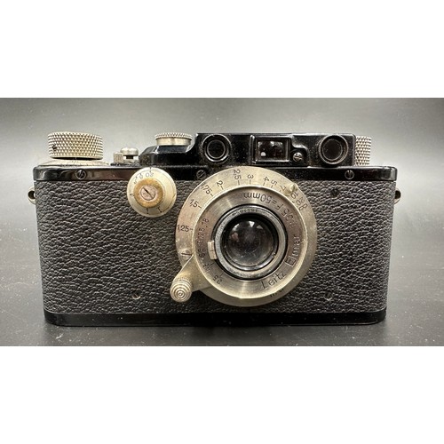 A Leica III 35mm rangefinder camera, black, 1935. With a A Leica III 35mm rangefinder camera, black, 1935. With a