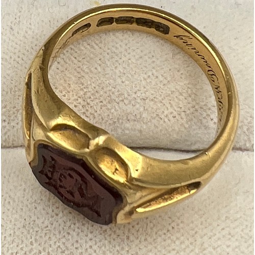 497 - An 18 carat gold signet ring with onyx initialled seal to the front. Weight 11.8gm. Inscribed inside... 