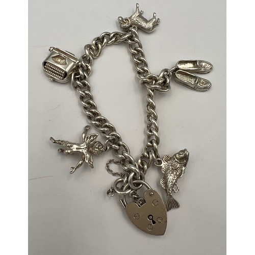 499 - Silver charm bracelet with five charms. Weight 30.5gm.