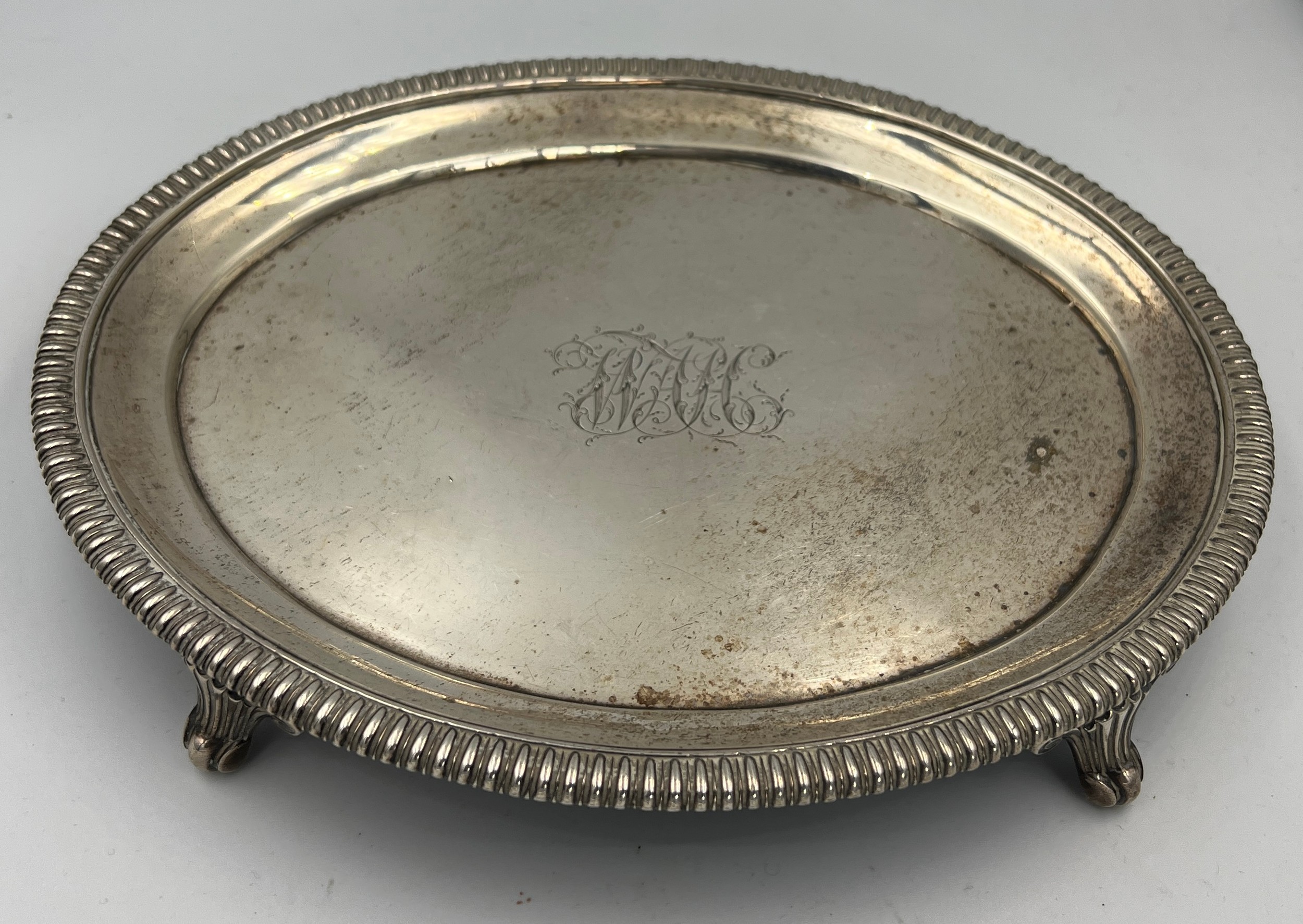 An oval silver tray raised on four feet. London 1809, maker Robert ...