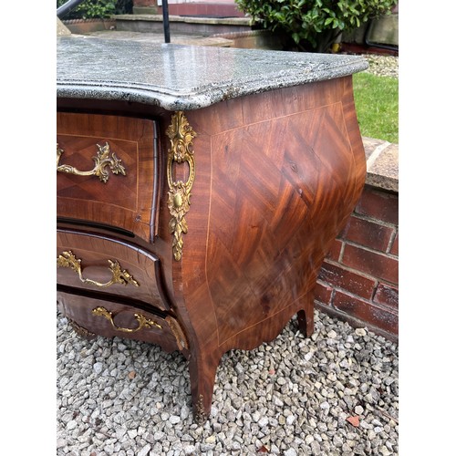 108 - A continental parquetry inlaid bombe fronted commode of three drawers with ormolu mounts and marble ... 