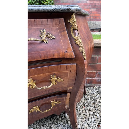 108 - A continental parquetry inlaid bombe fronted commode of three drawers with ormolu mounts and marble ... 