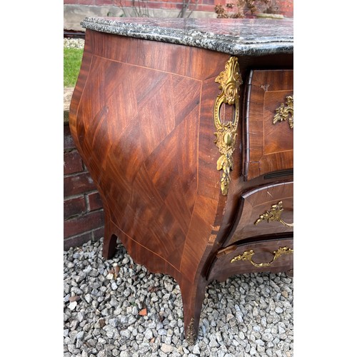 108 - A continental parquetry inlaid bombe fronted commode of three drawers with ormolu mounts and marble ... 