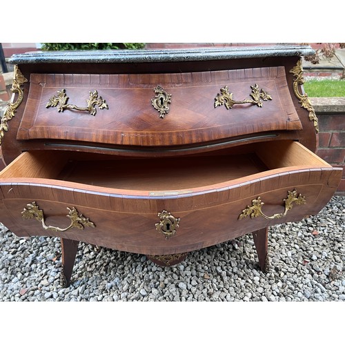 108 - A continental parquetry inlaid bombe fronted commode of three drawers with ormolu mounts and marble ... 