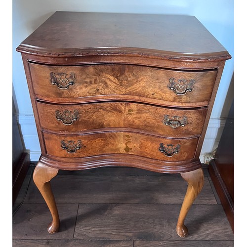 114 - A three drawer serpentine fronted burr walnut chest of drawers with brass drop handles raised on cab... 