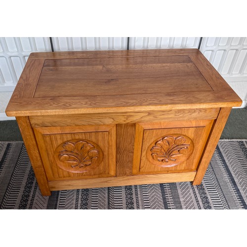 117 - An oak blanket box with carved panels to front. 84 w x 48 d x 53cm h.