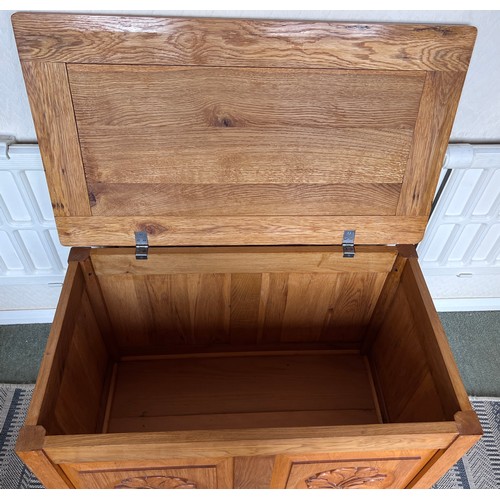 117 - An oak blanket box with carved panels to front. 84 w x 48 d x 53cm h.