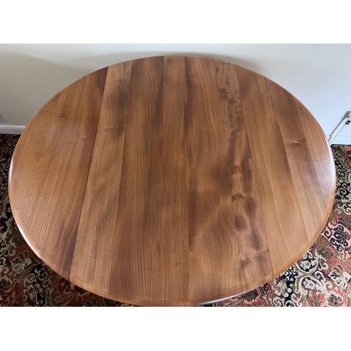 119 - An Ercol drop leaf dining table. Closed 113 w 61 d x 71cm h. Open 113 x 124cm.