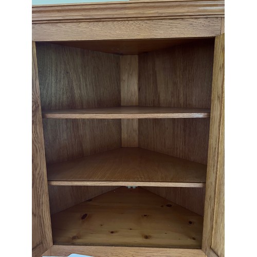 120 - A good quality handmade oak corner cupboard. 109 h x 98 w x 54.5cm.