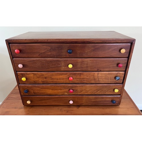 123 - A 5 height small chest with multicoloured knobs. 61 w x 30.5 d x 40.5cm h.