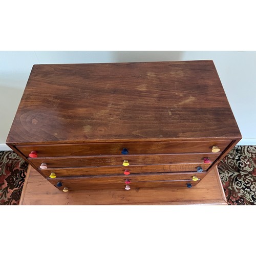 123 - A 5 height small chest with multicoloured knobs. 61 w x 30.5 d x 40.5cm h.