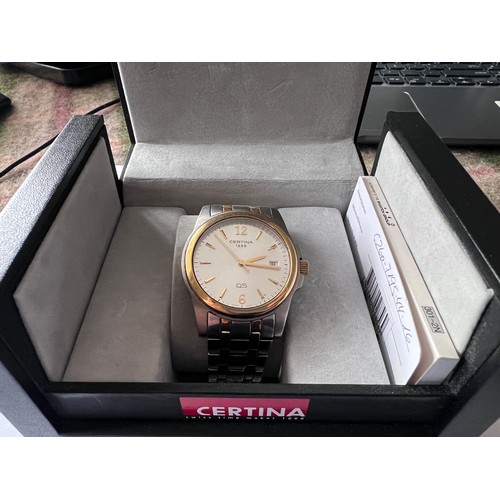 569 - A Certina DS battery operated wristwatch with date aperture on gold and silver coloured bracelet. In... 