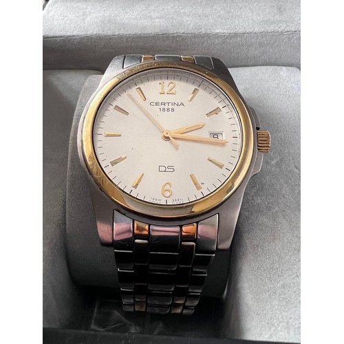 569 - A Certina DS battery operated wristwatch with date aperture on gold and silver coloured bracelet. In... 