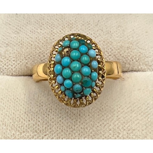 505 - A yellow metal ring with turquoise stones. Size N/O. Weight 4.1gm.