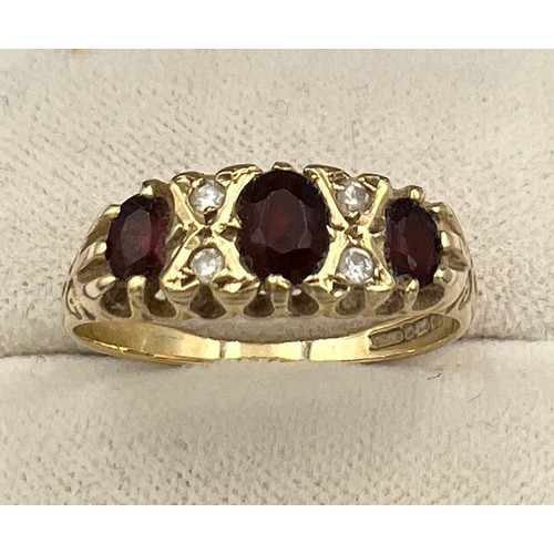 509 - A 9 carat gold ring set with garnets and diamonds. Size O/P. Weight 2gm.